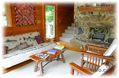 Living room with beautiful gas stone fireplace for a cozy atmoshere - Blue Ridge Parkway Lodging